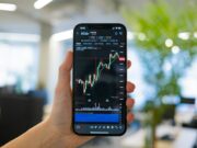 Эффективная торговля криптовалютами через мобильные приложения a person holding a cell phone in their hand