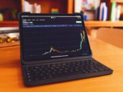 Как выбрать стратегию стейкинга для прибыли a laptop computer sitting on top of a wooden desk