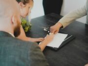 Умные контракты для пассивного дохода a woman showing a man something on a tablet