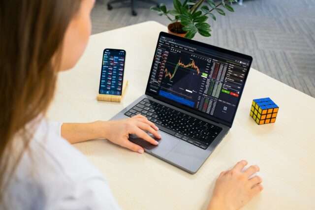 Photo by TabTrader.com a woman sitting at a table using a laptop computer