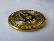 Преимущества смарт-контрактов в защите активов a gold bit coin sitting on top of a white table